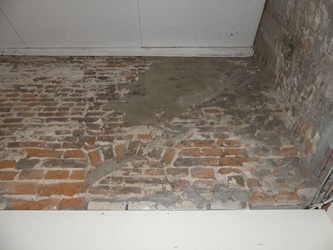 <p>Een muurfragment op de begane grond van het rechter pakhuis is een belangrijk restant van de oorspronkelijke achtergevel van dit pand.</p>
